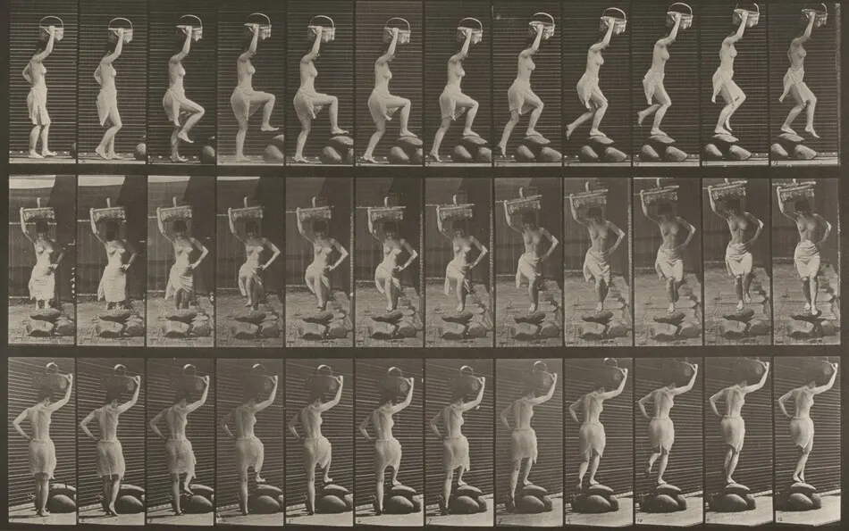 Plate Number 179. Stepping on and over a rock, a basket on head and right hand raised by Eadweard Muybridge